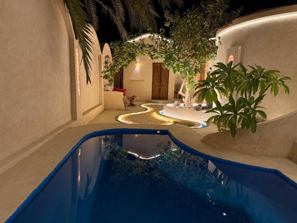 Private pool and lantern-lit courtyard of the pool suite at night