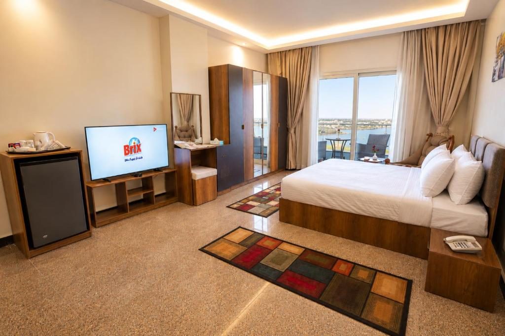 Bright guest room with a balcony overlooking the Nile