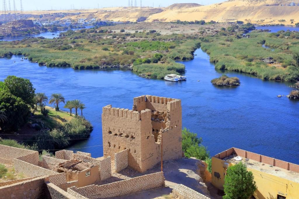 View over the Nile, its islands and an old mud-brick tower
