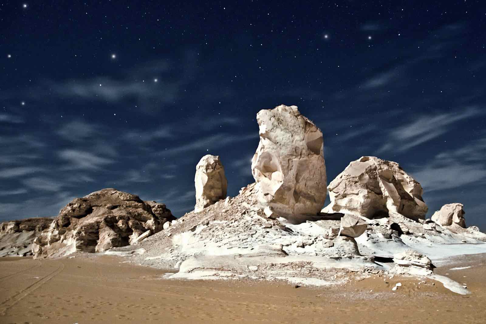 White Desert chalk formations under a starry night sky